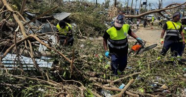 Rescue workers attempt to clear a blocked road, in the aftermath of Cyclone Chido, within Labattoir, in Mayotte, France, Dec. 15, 2024. (Reuters Photo)