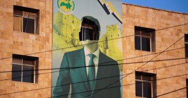 A damaged poster of the deposed Syrian despot Bashar Assad in Aleppo, following a major attack by anti-regime forces who swept into the city, Syria, Nov. 30, 2024. (Reuters File Photo)
