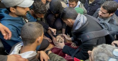 Khaled Nabhan's lifeless body is taken from the morgue of Awde Hospital for funeral prayers and burial after an Israeli attack at the Nuseirat refugee camp in Gaza City, Dec. 16, 2024. (AA Photo)