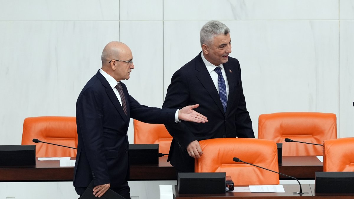 Treasury and Finance Minister Mehmet Şimşek (L) gestures next to Trade Minister Ömer Bolat during 2025 budget talks at Parliament, Ankara, Türkiye, Dec. 16, 2024. (AA Photo)