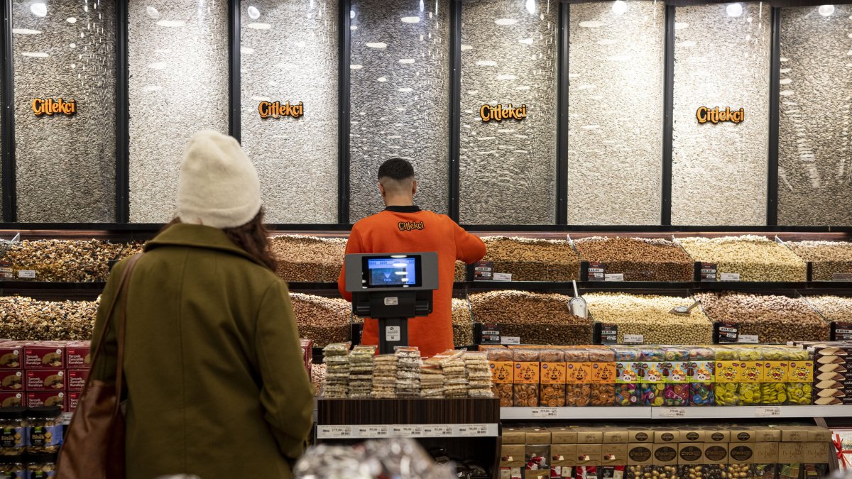 A customer is photographed in a store full of dry fruits and nuts, at an undisclosed location, Türkiye, Dec. 14, 2024. (AA Photo)