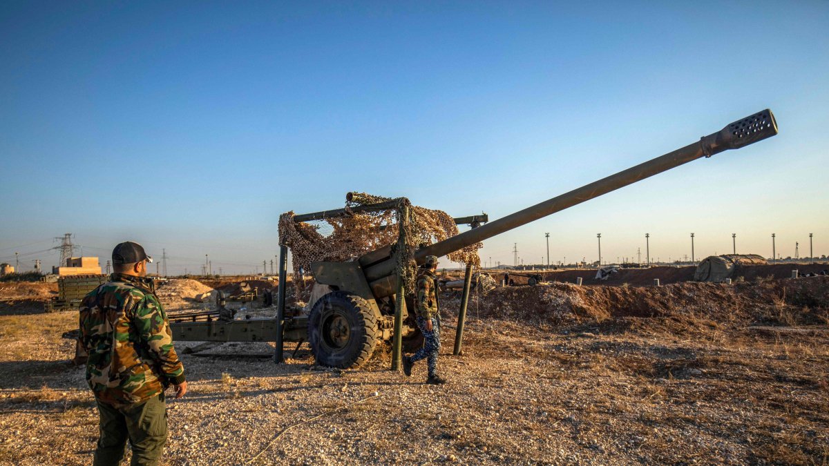 PKK/YPG terrorists inspect damaged and abandoned vehicles at a former Syrian-Russian military base, in Qamishli, Syria, Dec. 9, 2024. (AFP Photo) 