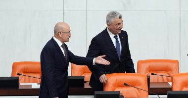 Treasury and Finance Minister Mehmet Şimşek (L) gestures next to Trade Minister Ömer Bolat during 2025 budget talks at Parliament, Ankara, Türkiye, Dec. 16, 2024. (AA Photo)