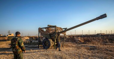 PKK/YPG terrorists inspect damaged and abandoned vehicles at a former Syrian-Russian military base, in Qamishli, Syria, Dec. 9, 2024. (AFP Photo) 