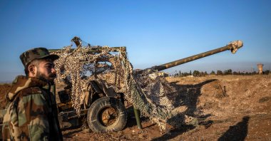 Terrorist YPG/PKK-led SDF fighter inspects damaged and abandoned military vehicles and equipment at the Qamishli International Airport, formerly a joint Syrian-Russian military base, in northeastern Syria's city of Qamishli on Dec. 9, 2024. (AFP Photo)