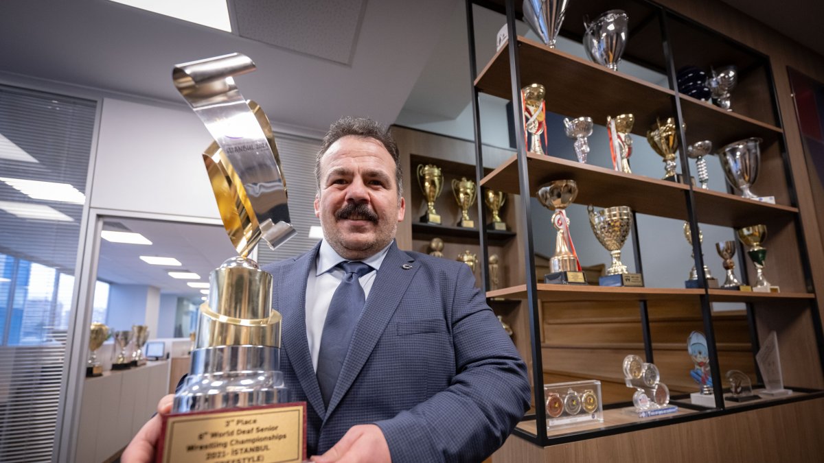 Turkish Deaf Sports Federation (TIESF) President Dursun Gözel poses with a World Wrestling Federation trophy, Ankara, Türkiye, Dec. 9, 2024. (AA Photo)