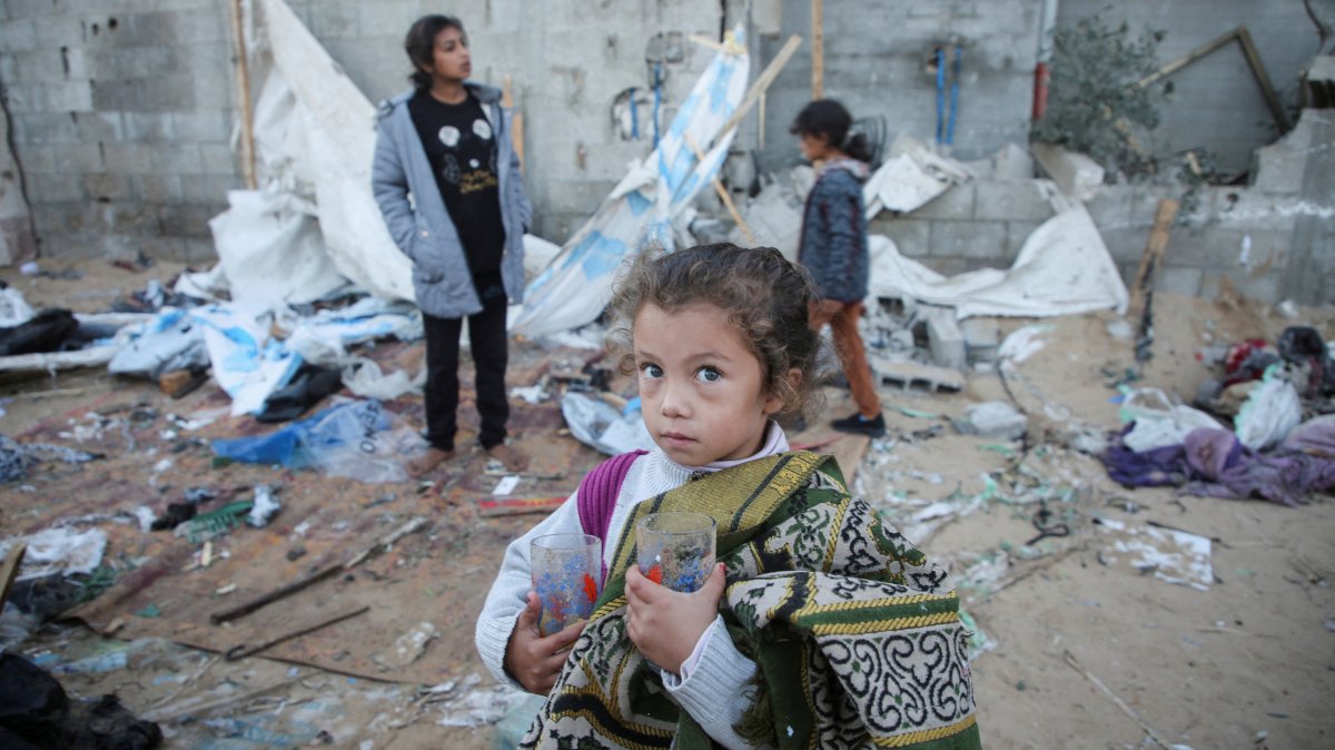 A Palestinian girl holds glasses in her hands as she stands at a tent camp sheltering displaced people, in Khan Younis, southern Gaza Strip, Palestine, Dec. 18, 2024. (Reuters Photo)