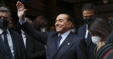 Former Italian Premier Silvio Berlusconi waves to reporters as he arrives at the Chamber of Deputies to meet Mario Draghi, Rome, Italy, Feb. 9, 2021. (AP Photo)