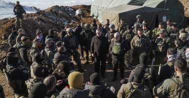 Israeli Prime Minister Benjamin Netanyahu (C-R) and Defense Minister Israel Katz (C-L) stand among Israeli troops at Jabal al-Shaykh or Mount Hermon in the occupied Golan Heights, Syria, Dec. 17, 2024.