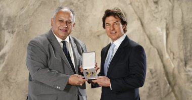 Actor Tom Cruise (R), is presented with the US Navy Distinguished Public Service Award by U.S. secretary of the Navy, Carlos Del Toro, during a ceremony at Long Cross Studios in Chertsey, Surrey, U.K., Dec. 17, 2024. (AP Photo)