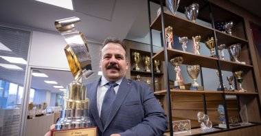 Turkish Deaf Sports Federation (TIESF) President Dursun Gözel poses with a World Wrestling Federation trophy, Ankara, Türkiye, Dec. 9, 2024. (AA Photo)