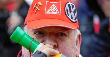 An employee blows into a horn during a warning strike by the IG Metall union, in front of VW headquarters in Wolfsburg, Germany, Dec. 9, 2024. (Reuters Photo)