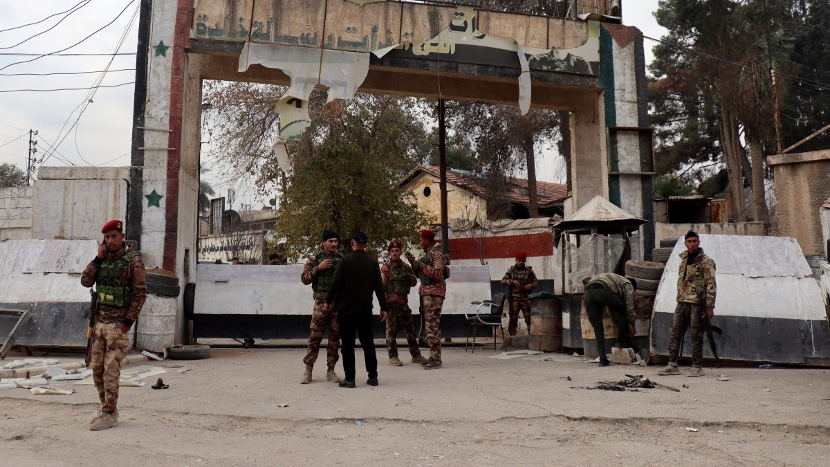 PKK/YPG terrorists stand at the entrance of a government headquarters after they took control of the northeast city of Hassakeh, Syria, Dec. 8, 2024. (EPA Photo)