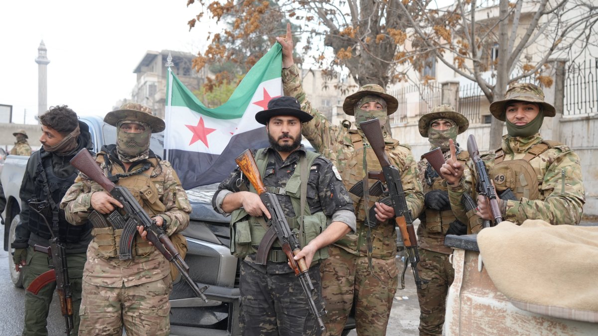 Syrian National Army (SNA) members pose with their weapons after seizing Manbij from PKK/YPG terrorists, northern Syria, Dec. 13, 2024. (İHA Photo)