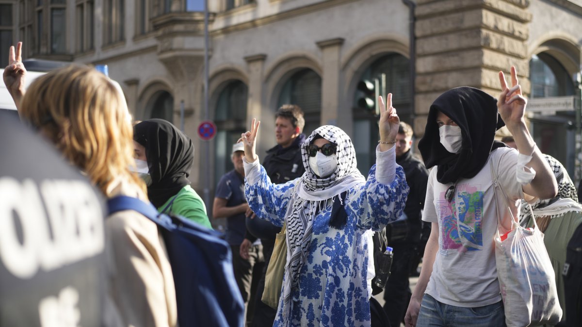 Pro-Palestinian demonstrators who show the victory sign are escorted by police as they leave a building of  the Humboldt University in Berlin, Germany, Thursday, May 23, 2024. (AP File Photo)