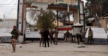 PKK/YPG terrorists stand at the entrance of a government headquarters after they took control of the northeast city of Hassakeh, Syria, Dec. 8, 2024. (EPA Photo)