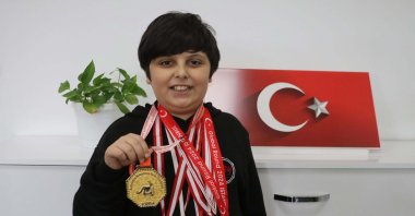 Selahattin Çınar Öner holds his medal after winning the world title in the American Math Olympiad, Denizli, Türkiye, Dec. 19, 2024. (DHA Photo)