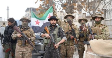 Syrian National Army (SNA) members pose with their weapons after seizing Manbij from PKK/YPG terrorists, northern Syria, Dec. 13, 2024. (İHA Photo)