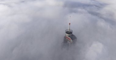 Avaz Twist Tower building, 172 meters high, peaks through a dense layer of fog and smog in Sarajevo, Bosnia-Herzegovina, Dec. 19, 2024. (AP Photo)