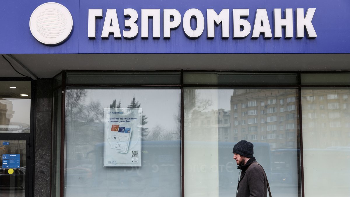 A man walks past a branch office of Gazprombank in Moscow, Russia March 31, 2022. (Reuters Photo)