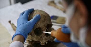 An expert examines the skeleton discovered in the excavations at Fethiye Castle in Muğla, Türkiye, Dec. 12, 2024. (AA Photo)