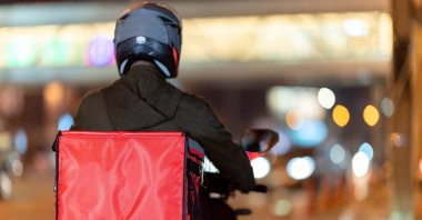 Couriers navigate busy streets for quick deliveries. (Shutter Stock Photo)