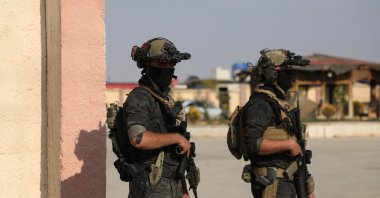 Members of the YPG-dominated SDF stand together as they hold their weapons in Hassakeh, Syria, Dec. 6, 2024. (Reuters Photo)
