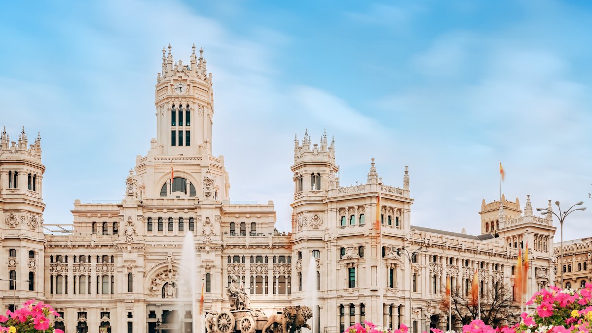 Madrid City Hall on Cibeles Square with a flower garden in the foreground in Madrid, Spain. (Shutterstock Photo)