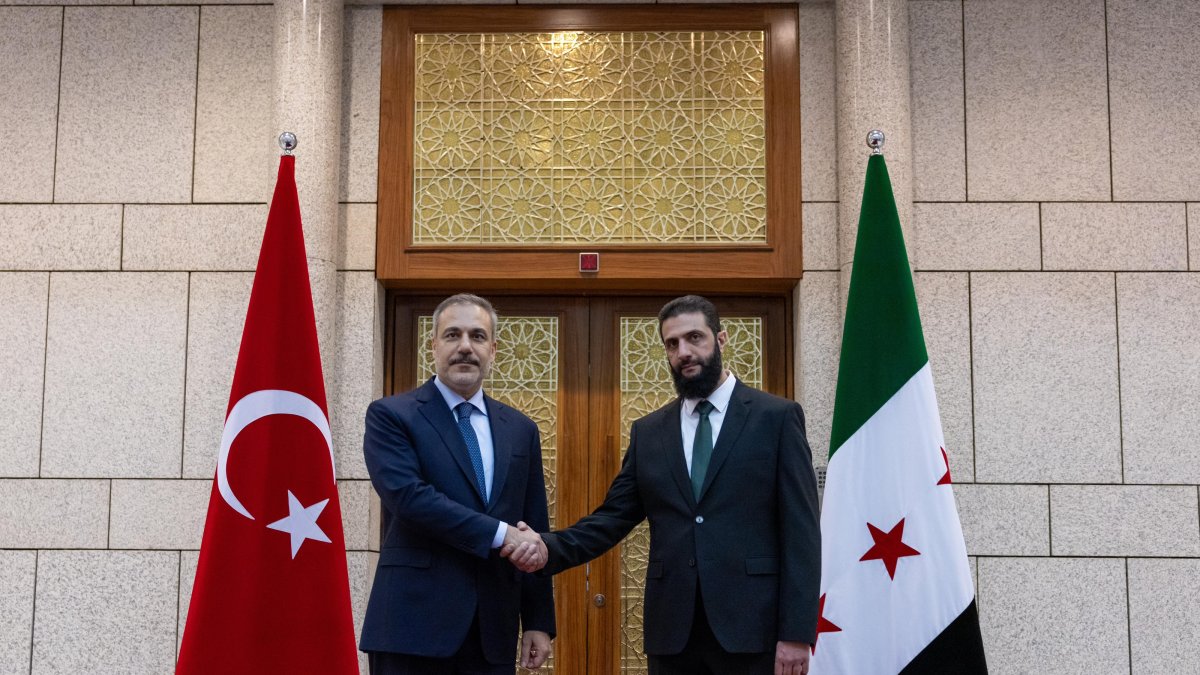 Foreign Minister Hakan Fidan (L) shakes hands with Ahmed al-Sharaa, in Damascus, Syria, Dec. 22, 2024. (AA Photo) 