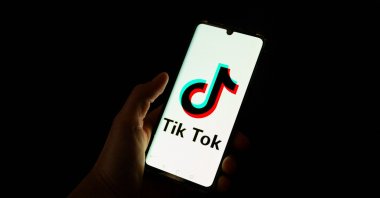 A man holds a smartphone displaying the logo of the Chinese social media platform Tiktok, Paris, France, April 19, 2024. (AFP Photo)
