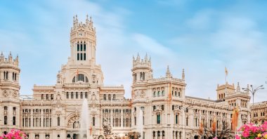Madrid City Hall on Cibeles Square with a flower garden in the foreground in Madrid, Spain. (Shutterstock Photo)