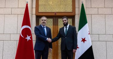 Foreign Minister Hakan Fidan (L) shakes hands with Ahmed al-Sharaa, in Damascus, Syria, Dec. 22, 2024. (AA Photo) 