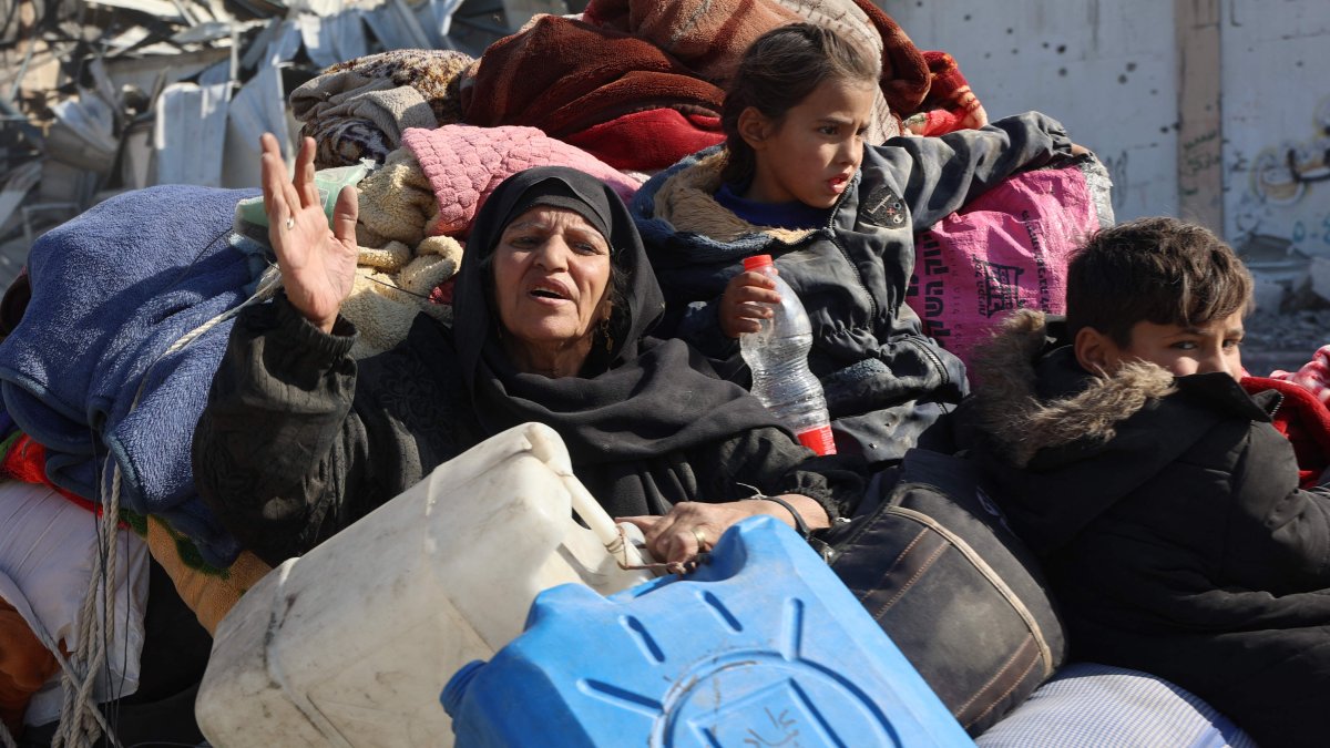 A Palestinian woman reacts as she sits with relatives in the back of a cart as displaced people from Beit Lahia arrive in Jabalia, northern Gaza Strip, Palestine, Dec. 4, 2024. (AFP Photo)