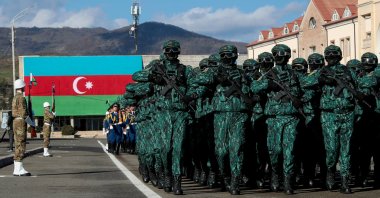 In this photo provided by Azerbaijan's Presidential Press Office, troops march past Azerbaijani President Ilham Aliyev during a parade dedicated to the third anniversary of the Victory in the Patriotic War in Khankendi, Khankendi, Azerbaijan, Nov. 8, 2023. (AP Photo)
