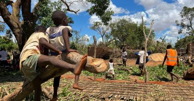 Residents affected following cyclone Chido walk around their home in Pemba, Mozambique, December 18, 2024. REUTERS/Shafiek Tassiem