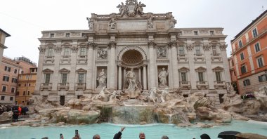 Rome&#039;s Mayor Roberto Gualtieri tosses a coin into the Trevi Fountain as it reopens to the public after maintenance work, Rome, Italy, Dec. 22, 2024. (Reuters Photo)