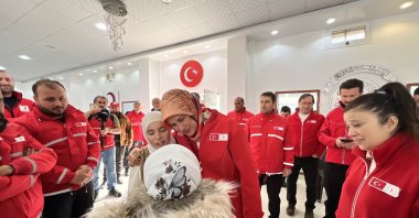 Fatma Meriç Yılmaz meets with children during her visit to the Turkish Red Crescent bakery and logistics center in Idlib, Syria, Dec. 22, 2024. (AA Photo)