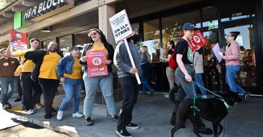 Starbucks workers hold signs as they picket during a strike in front of a Starbucks to demand collective bargaining agreements in Burbank, California, U.S., Dec. 20, 2024. (AFP Photo)