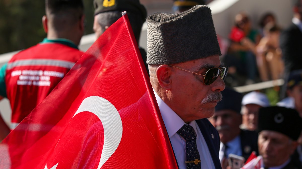 A man holds a Turkish flag during celebrations marking the 50th anniversary of Türkiye&#039;s intervention in the conflict in Cyprus, Lefkosia, TRNC, July 20, 2024. (Getty Images)