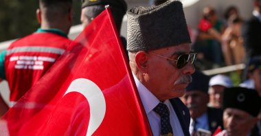 A man holds a Turkish flag during celebrations marking the 50th anniversary of Türkiye&#039;s intervention in the conflict in Cyprus, Lefkosia, TRNC, July 20, 2024. (Getty Images)