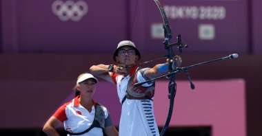 Turkish archers Mete Gazoz (R) and Yasemin Ecem Anagöğüz in action during the Tokyo Olympics mixed team round of 16 at Yumenoshima Park Archery Area, Tokyo, Japan, July 25, 2021. (AA Photo)