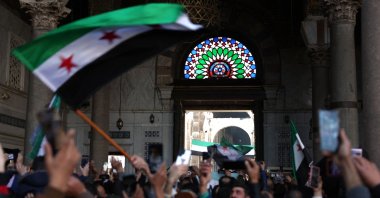 Syrians wave the new Syrian flag after Friday Noon prayers at the Umayyad Mosque in the capital Damascus, Syria, Dec. 20, 2024. (AFP Photo)