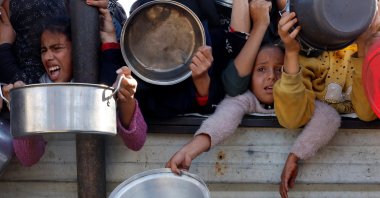 Palestinian children gather to receive food cooked by a charity kitchen amid a hunger crisis in Khan Younis, southern Gaza Strip, Palestine, Dec. 4, 2024. (Reuters Photo)