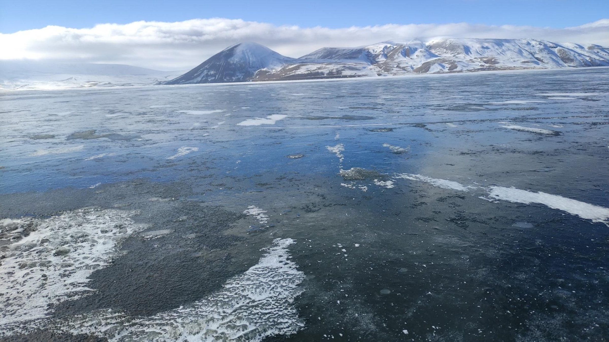 The frozen surface of Balık Lake, surrounded by snow-covered mountains, in Ağrı, Türkiye, Dec. 26, 2024. (IHA Photo)