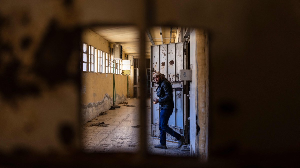 A Syrian man inspects cells at the prison of Sednaya, north of Damascus, Syria, Dec. 16, 2024. (AFP Photo)