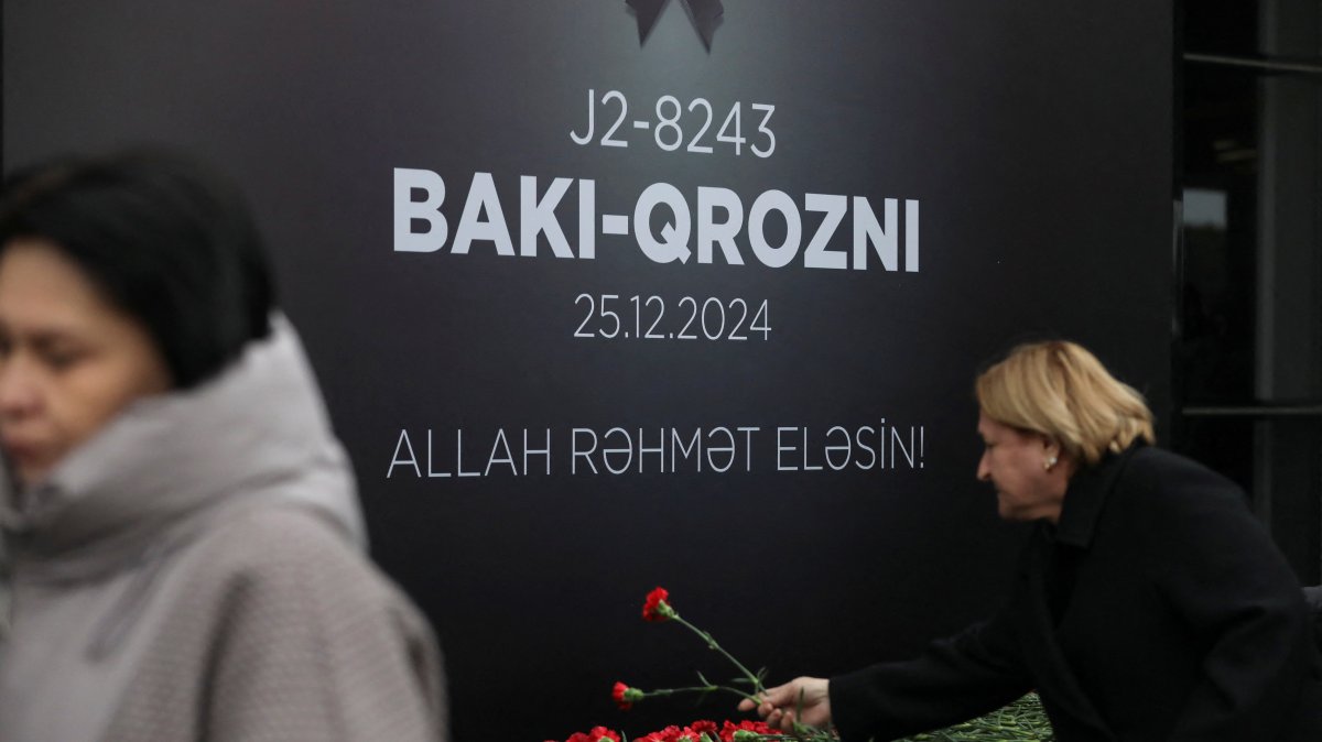 People lay flowers to commemorate Azerbaijan Airlines plane crash victims at a memorial installed outside an airport in Baku, Azerbaijan, Dec. 26, 2024. (Reuters Photo)