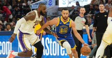 Golden State Warriors guard Stephen Curry (R) dribbles past Los Angeles Lakers forward LeBron James during the third quarter at Chase Center, San Francisco, California, U.S., Dec. 25, 2024. (Reuters Photo)
