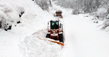 This aerial photograph shows snowploughts clearing snow to access road toward Knezevo, on Mt. Vlasic, in central Bosnia, Dec. 25, 2024. (AFP Photo)