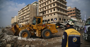 An excavator cleans debris from a damaged building as a part of a reparation campaign in Aleppo, Syria, Dec. 25, 2024. (EPA Photo)