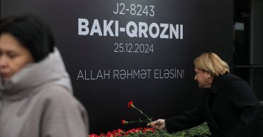 People lay flowers to commemorate Azerbaijan Airlines plane crash victims at a memorial installed outside an airport in Baku, Azerbaijan, Dec. 26, 2024. (Reuters Photo)